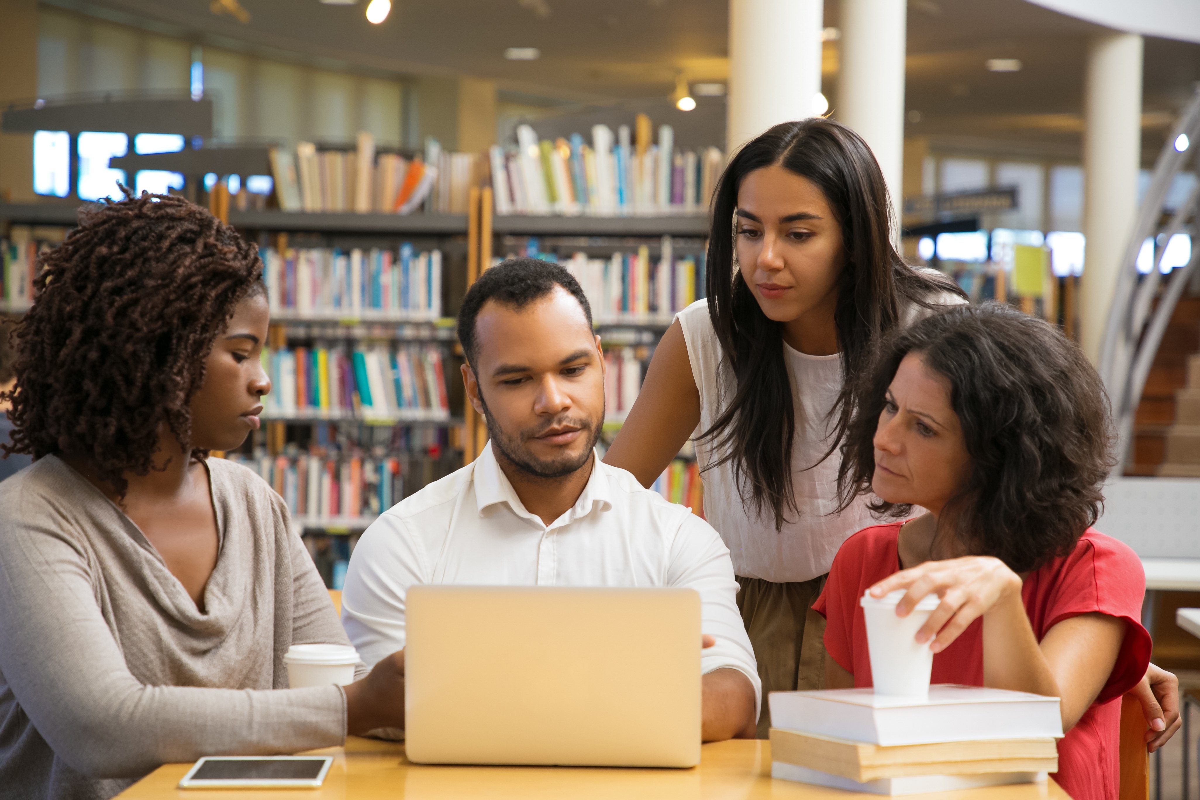 concentrated-young-people-reading-information-from-laptop