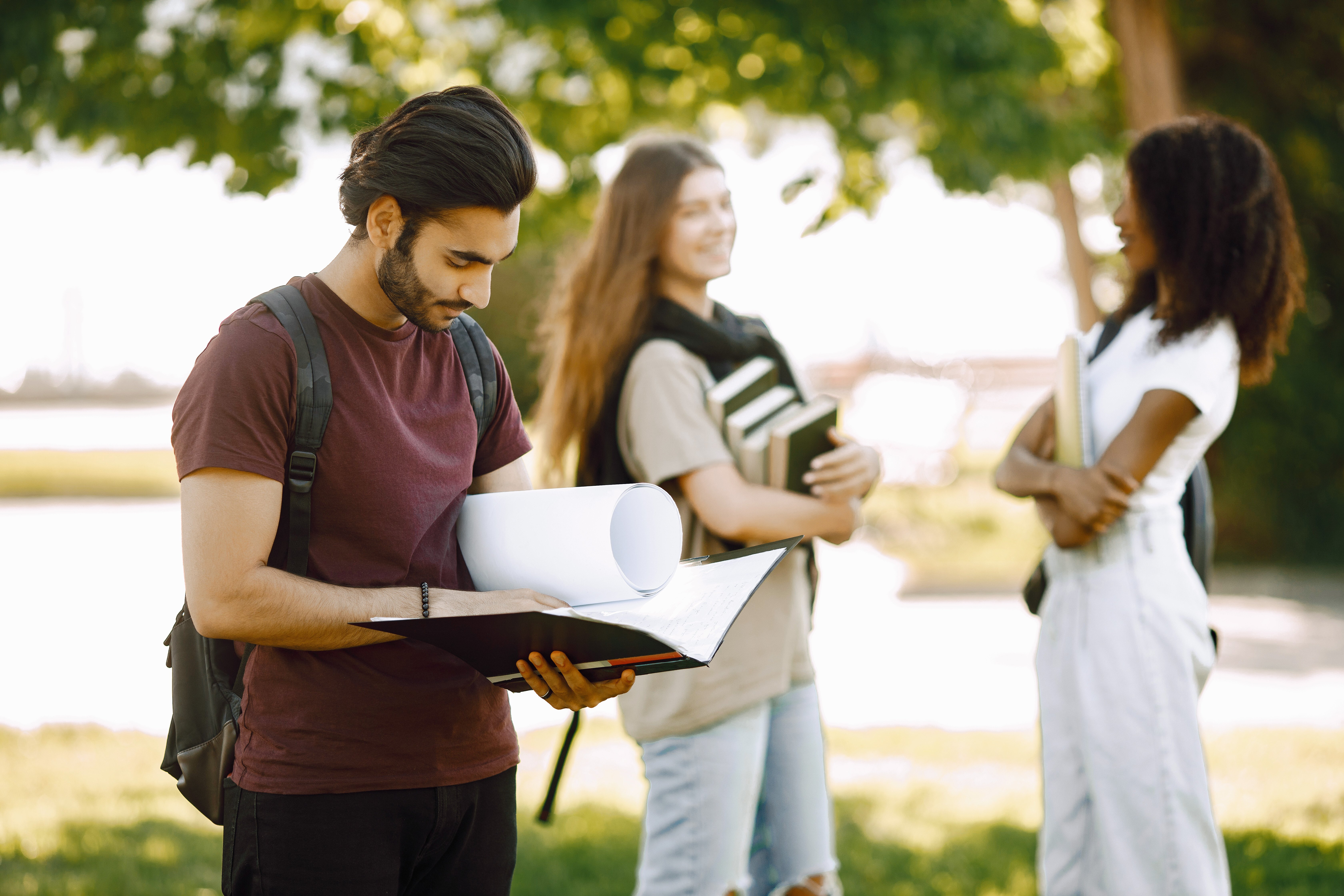 focus-indian-boy-who-standing-sepately-group-international-students-standing-together-park-university