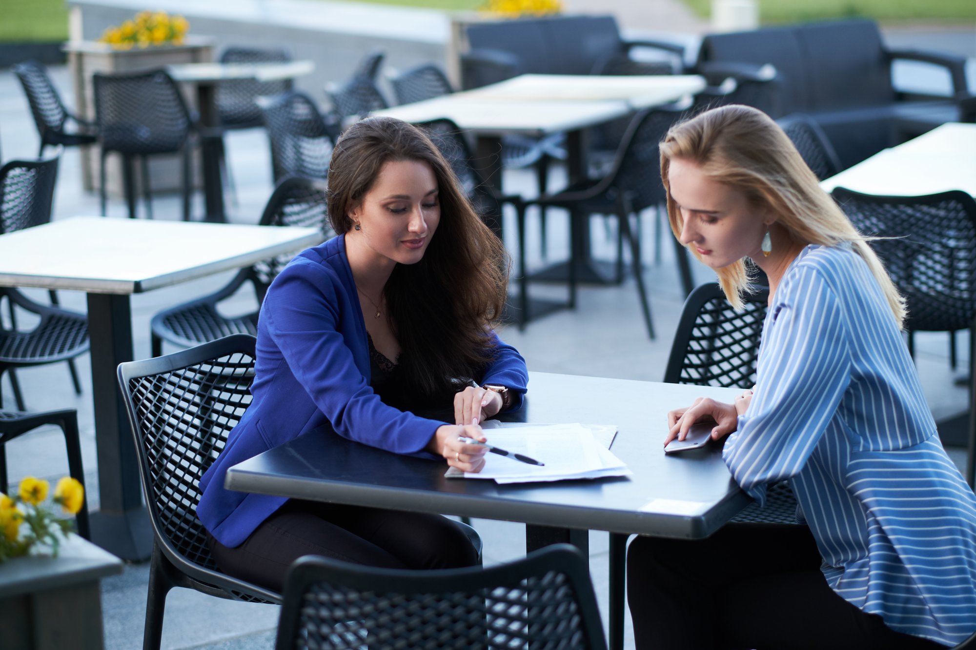 two-cooperative-workers-are-disscussing-new-project-outside-office-caffeteria-nice-summer-day (2)