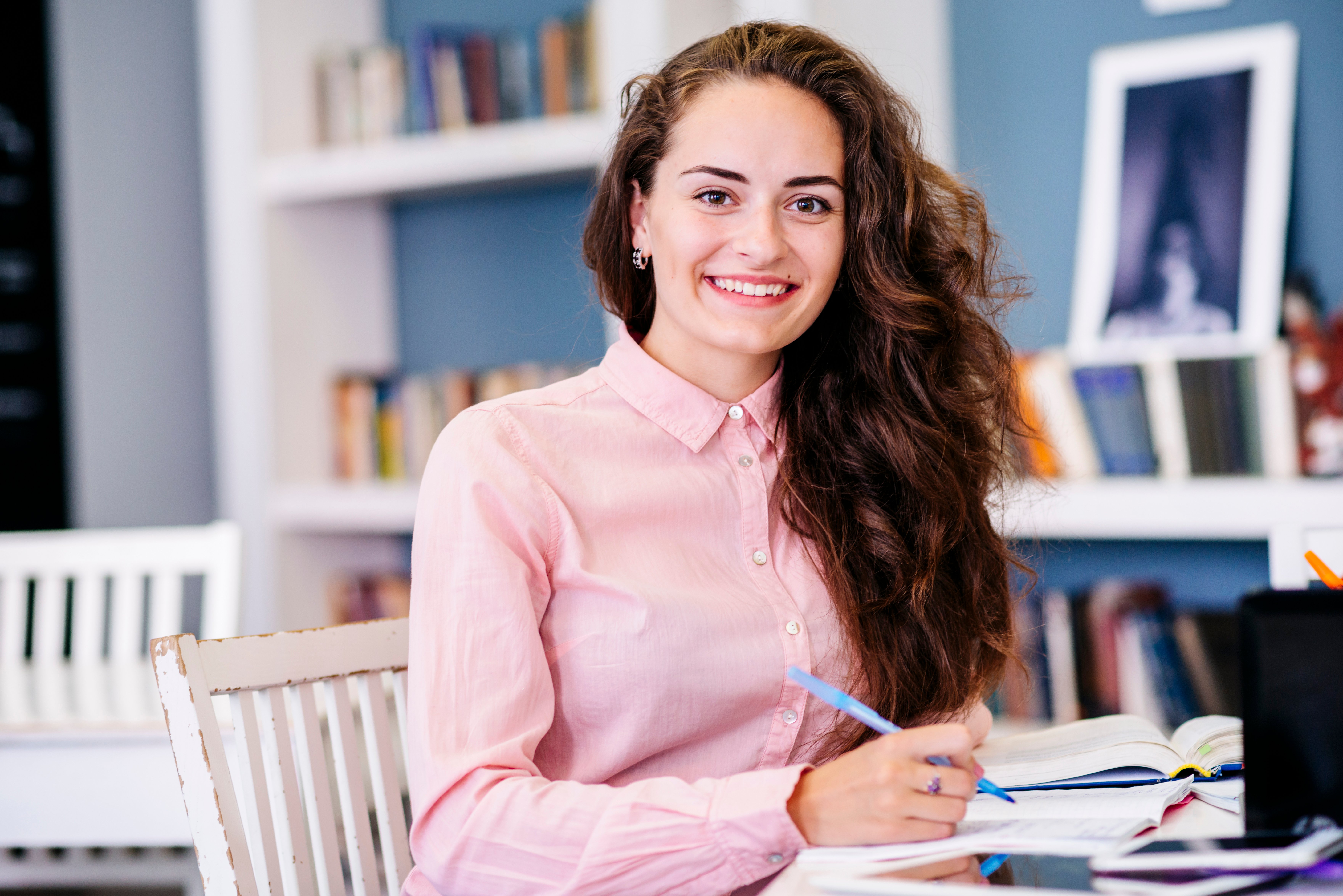 woman-sitting-table-with-pen