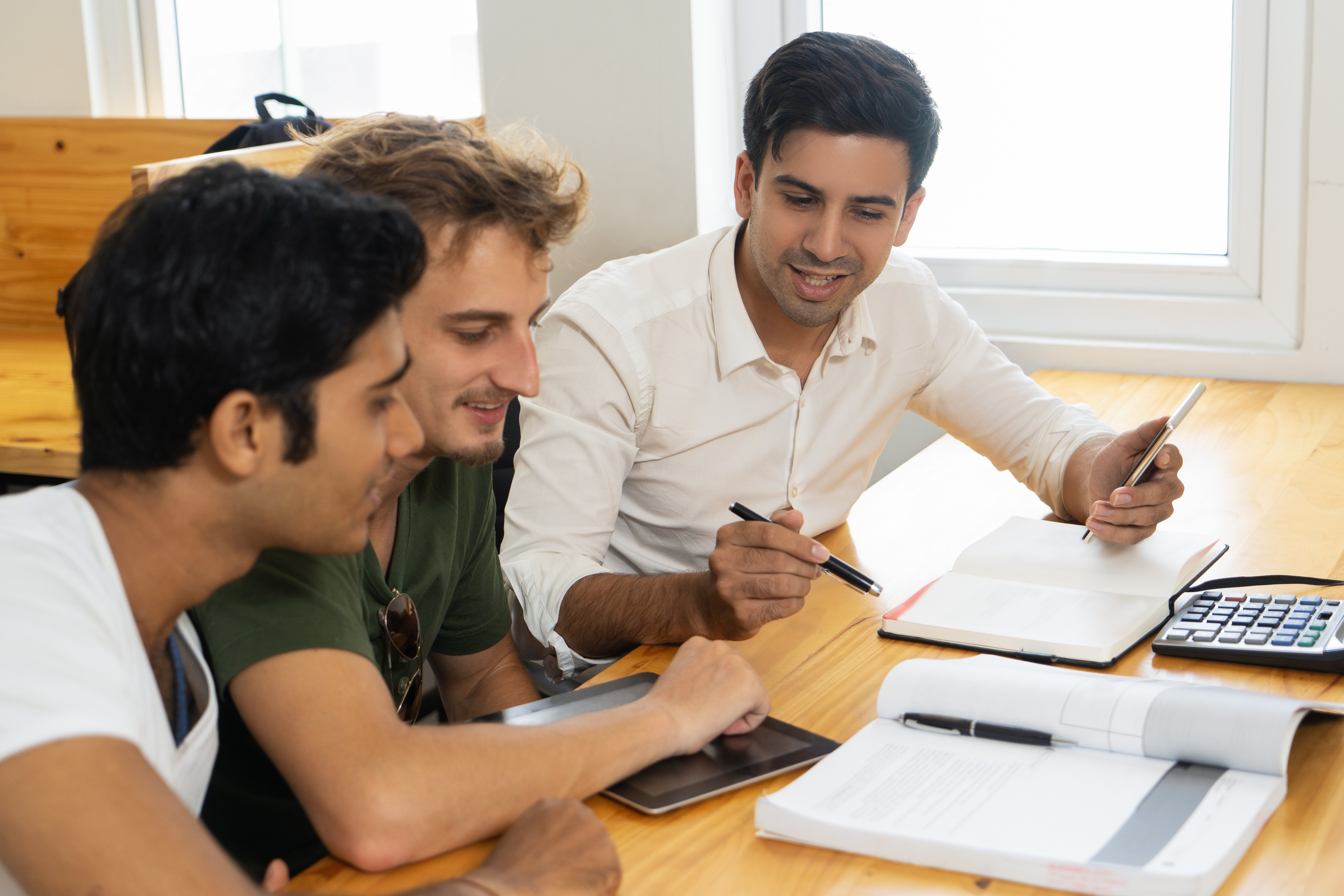 young-teacher-telling-two-students-about-corporate-budgeting